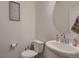 Cozy bathroom with a round mirror and toilet with a decorative sign at 21538 E 59Th Pl, Aurora, CO 80019