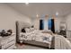 Spacious bedroom with a large tufted headboard and neutral decor at 21538 E 59Th Pl, Aurora, CO 80019