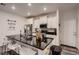 Contemporary kitchen featuring a sleek island with seating and modern stainless steel appliances at 21538 E 59Th Pl, Aurora, CO 80019