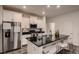 Modern kitchen with stainless steel appliances, black countertops, and white cabinetry at 21538 E 59Th Pl, Aurora, CO 80019