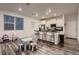 Modern kitchen with white cabinetry, stainless steel appliances, and a breakfast bar at 21538 E 59Th Pl, Aurora, CO 80019