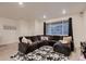 Comfortable living area with large sectional sofa, a big window, and an area rug at 21538 E 59Th Pl, Aurora, CO 80019