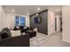 Inviting living room featuring a dark accent wall and cozy seating area at 21538 E 59Th Pl, Aurora, CO 80019