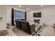 Cozy living room features a plush sectional sofa, large window, and stylish rug at 21538 E 59Th Pl, Aurora, CO 80019