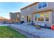 View of the backyard patio with outdoor furniture and barbecue grill; a perfect spot for outdoor entertainment and relaxation at 9448 Richfield St, Commerce City, CO 80022