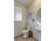 Charming half-bathroom with a pedestal sink and decorative nautical-themed wall decor at 9448 Richfield St, Commerce City, CO 80022