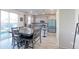 Modern kitchen with gray cabinets, stainless steel appliances, and a spacious dining area, perfect for entertaining at 9448 Richfield St, Commerce City, CO 80022