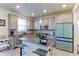 Elegant kitchen featuring gray cabinetry, stainless steel appliances, and an island with bar seating at 9448 Richfield St, Commerce City, CO 80022
