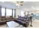 Open-concept living room connected to a modern kitchen, featuring cozy seating and plenty of natural light at 9448 Richfield St, Commerce City, CO 80022