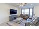 Cozy living room featuring a large TV, plush leather sofas, and elegant decor, ideal for relaxation at 9448 Richfield St, Commerce City, CO 80022