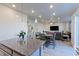 Open concept living room and dining area features modern lighting and plenty of natural light at 9448 Richfield St, Commerce City, CO 80022