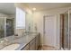 The bathroom features a double vanity, granite countertops, and a glass-enclosed shower at 9448 Richfield St, Commerce City, CO 80022