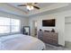 The main bedroom includes a ceiling fan and a window providing plenty of natural light at 9448 Richfield St, Commerce City, CO 80022