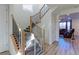 Bright foyer showcasing a staircase with modern railing and light wood floors, leading to the upper level at 9448 Richfield St, Commerce City, CO 80022
