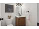 Stylish powder room features modern vanity with black faucet, toilet, and decorative mirror at 3855 S Monaco St # 182, Denver, CO 80237