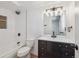 Bright bathroom features updated shower over tub, modern vanity, and sleek fixtures at 3855 S Monaco St # 182, Denver, CO 80237