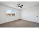 Bright bedroom features a large window and a modern ceiling fan at 3855 S Monaco St # 182, Denver, CO 80237