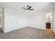 Neutral bedroom with carpet, ceiling fan, and access to ensuite bathroom at 3855 S Monaco St # 182, Denver, CO 80237