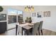 Dining area with outdoor access, modern lighting, decor, and views of the contemporary kitchen at 3855 S Monaco St # 182, Denver, CO 80237