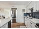 Bright kitchen offers stainless steel appliances, subway tile backsplash, quartz countertops, and wood flooring at 3855 S Monaco St # 182, Denver, CO 80237