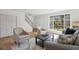 Living room with hardwood floors, a large window, comfortable seating, and access to upper floors at 3855 S Monaco St # 182, Denver, CO 80237