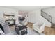 Open-concept living space flowing into dining, featuring hardwood floors and contemporary decor at 3855 S Monaco St # 182, Denver, CO 80237