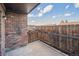 Private patio with brick surround and wood fence providing a quiet retreat at 3855 S Monaco St # 182, Denver, CO 80237