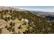 Aerial view showcases property surrounded by trees and mountains at 1426 Rembrandt Rd, Boulder, CO 80302
