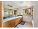 Bathroom with double sinks, a window, and ample cabinet space at 1426 Rembrandt Rd, Boulder, CO 80302