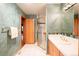 Well-lit bathroom with a glass enclosed shower and wood accents at 1426 Rembrandt Rd, Boulder, CO 80302