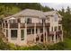 Three-story home featuring multiple decks, stone accents, and large windows at 1426 Rembrandt Rd, Boulder, CO 80302