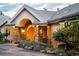 Charming front entrance with stone accents, a custom wooden door, and lush landscaping at 1426 Rembrandt Rd, Boulder, CO 80302