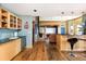 Open floor plan with bar seating, wood floors and views of the TV room at 1426 Rembrandt Rd, Boulder, CO 80302