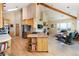 Open-concept living space seamlessly integrates the kitchen, dining, and living areas with vaulted ceilings and natural light at 1426 Rembrandt Rd, Boulder, CO 80302