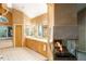 Bright bathroom features a double vanity, soaking tub, and see-through fireplace at 1426 Rembrandt Rd, Boulder, CO 80302