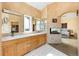 Large primary bathroom includes a double vanity, walk-in closet, and see-through fireplace at 1426 Rembrandt Rd, Boulder, CO 80302