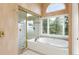 Bright bathroom showcasing a large soaking tub, a separate shower and a big window at 1426 Rembrandt Rd, Boulder, CO 80302