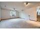 Finished basement with carpet, a ceiling fan, and natural light at 12036 Monaco Dr, Brighton, CO 80602