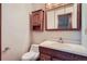 Traditional bathroom featuring a wood vanity, sink, and mirrored cabinet at 12036 Monaco Dr, Brighton, CO 80602