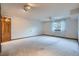 Spacious bedroom with a ceiling fan, window, and carpeted flooring at 12036 Monaco Dr, Brighton, CO 80602