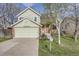 Charming two-story home with a well-maintained lawn, driveway and attached garage at 12036 Monaco Dr, Brighton, CO 80602