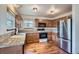 Kitchen featuring wooden cabinets, stainless steel appliances, and granite countertops at 12036 Monaco Dr, Brighton, CO 80602