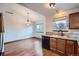 Bright kitchen and adjacent dining area featuring hardwood floors and ample natural light at 12036 Monaco Dr, Brighton, CO 80602
