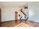 Spacious living room showcasing hardwood floors, vaulted ceiling, and staircase at 12036 Monaco Dr, Brighton, CO 80602