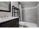 Clean bathroom with gray tile, shower, and vanity at 3052 S Grape Way, Denver, CO 80222
