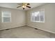 Well-lit bedroom with ceiling fan and window coverings at 3052 S Grape Way, Denver, CO 80222