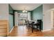 Bright dining area with green accent wall and backyard access at 3052 S Grape Way, Denver, CO 80222