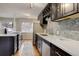 Modern kitchen with dark cabinets and quartz countertops at 3052 S Grape Way, Denver, CO 80222