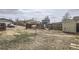 Spacious backyard with wood fence, shed, play set, and potential for landscaping and recreation at 130 Elm St, Hudson, CO 80642