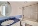 Bathroom features a white sink and toilet with a tiled tub/shower at 130 Elm St, Hudson, CO 80642
